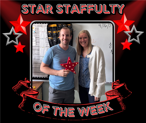 A smiling man holds the red star and poses with a woman who is also smiling.